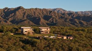 a house on a hill with mountains in the background at Cabañas Balcones de Nogolí II - San Luis in Hipólito Yrigoyen