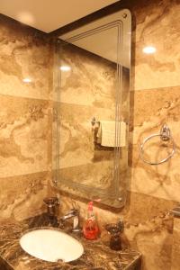 a bathroom with a sink and a mirror at Designer Den two Bed apartment opposite to giga mall in Islamabad +97 photos