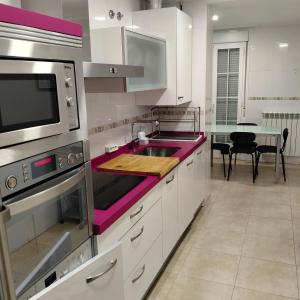 a kitchen with a pink counter top in it at Las heras apartamento in Medrano