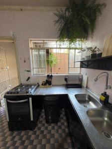 a kitchen with a sink and a counter top at Sobrado versátil in Santo André +62 photos