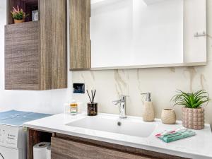 a kitchen with a white sink in a kitchen at Victoria Seafront - Sea View Private Parking AC & WiFi in Savona +19 photos