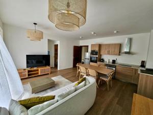 a living room with a couch and a table at Opatio residence 1314 in Tamarin