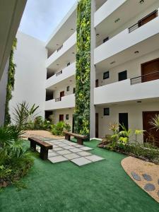 a courtyard with a bench and a building at Opatio residence 1314 in Tamarin