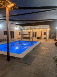 a swimming pool in a courtyard at night at los agaves lto in Loreto +5 photos