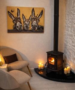 a living room with a fireplace and a picture of deer at Copper Cove at Lough Sillan House - Adults only in Shercock