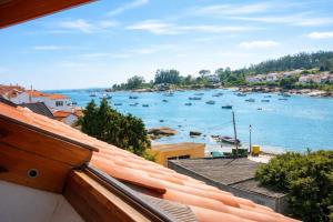 a view of a harbor with boats in the water at Pensión Rey in Isla de Arosa