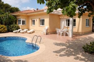 a villa with a swimming pool in front of a house at Casa Amor - "Pet Friendly - Piscina Privada - Playa - BBQ - Parking - Delta de l'Ebre - Riumar" in Riumar