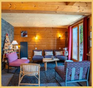 a living room with a couch and chairs and a table at Olaf Chalet IT5 I Les Gets in Les Gets