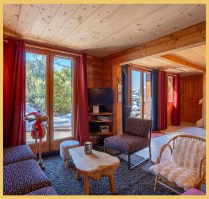 a living room with a couch and chairs and a tv at Olaf Chalet IT5 I Les Gets in Les Gets
