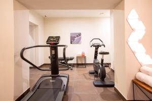 a gym with two exercise bikes in a room at Hotel & Spa Merilys in Méribel