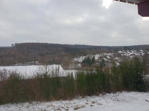 a view of a snow covered field with a snow covered lake at Ferienhaus 52 in Kirchheim