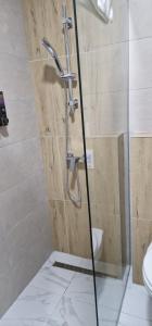 a shower with a glass door in a bathroom at Apartman Bety in Brčko