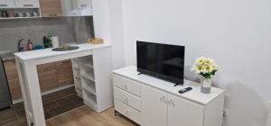a living room with a tv on a white dresser at Apartman Bety in Brčko