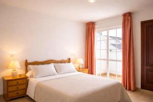 a bedroom with a bed and a large window at Pensión Rey in Isla de Arosa