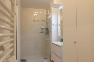 a white bathroom with a shower and a sink at Nice Time - Chic Apartment with sunny terrace, Nice Port in Nice