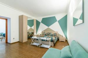 a bedroom with a bed with a geometric wall at ANTONELLI Apartment L'AQUILA in LʼAquila