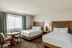 a hotel room with two beds and a table at Starr Pass Golf Suites in Tucson +16 photos
