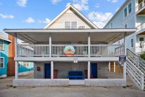 a large house with a deck on top of it at Sand Dollar Suites 2 in Carolina Beach