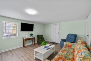a living room with a couch and a table at Sand Dollar Suites 2 in Carolina Beach