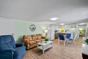 a living room with a couch and a table at Sand Dollar Suites 2 in Carolina Beach