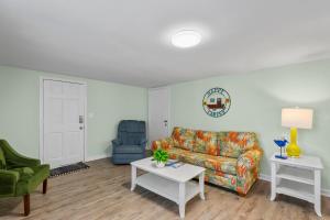 a living room with a couch and a table at Sand Dollar Suites 2 in Carolina Beach +20 photos