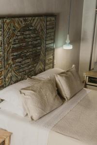 a white bed with two pillows on top of it at Al Cortile Del Seminario in Cefalù