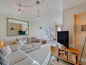 a living room with a couch and a flat screen tv at Frenchgate Cottage in Richmond