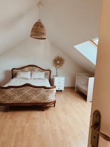 a bedroom with a bed in a attic at Le gîte de Marceau in Labergement-lès-Auxonne +29 photos