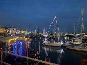a group of boats docked in a marina at night at Top-end penthouse with sea views and free parking in Ramsgate