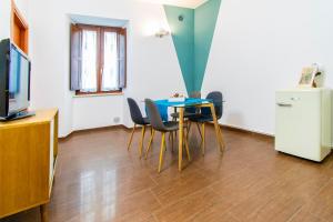 a dining room with a blue table and chairs at ANTONELLI Apartment L'AQUILA in LʼAquila