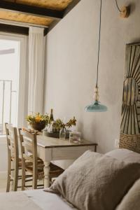 a bedroom with a table and chairs and a bed at Al Cortile Del Seminario in Cefalù