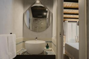 a bathroom with a large white tub and a mirror at Al Cortile Del Seminario in Cefalù +38 photos