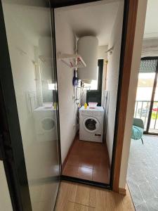 a small bathroom with a washing machine in a room at Ponte da Illa in Isla de Arosa