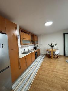 a kitchen with a sink and a table in it at Ponte da Illa in Isla de Arosa