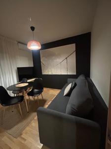 a living room with a couch and a table at Apartament Sołtysowska- garaż bezpłatny, NEAR Tauron Arena, EXPO in Krakow
