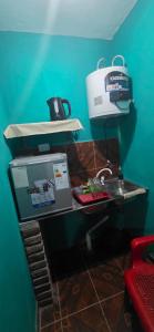 a bathroom with a sink and a box on a counter at Apart Fiambala alojamiento in Fiambalá