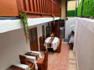 a room with a table and chairs in a building at Naty's Guest House in Cusco