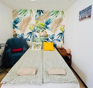 a living room with a large bed and a couch at Ático Sol Vecindario in Vecindario
