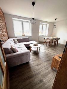 a living room with a couch and a table at Apartmány Bozen Lednice in Lednice