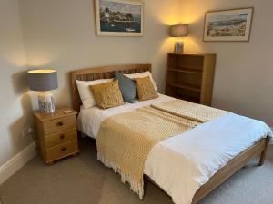 a bedroom with a large bed and a night stand at Tresithick Vean Bed and Breakfast in Truro