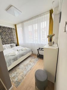 a small bedroom with a bed and a window at ÁTRIUM Apartman Kaposvár in Kaposvár +43 photos
