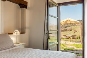 a bedroom with a bed and a sliding glass door at Villa Del Sole in San Gimignano +120 photos