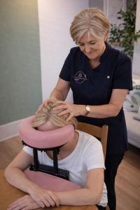 a woman cutting a mans hair in a salon at Corner House Studio in Skipton