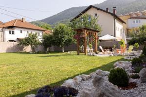 a yard with a house and a gazebo at Villa Igman in Hrasnica