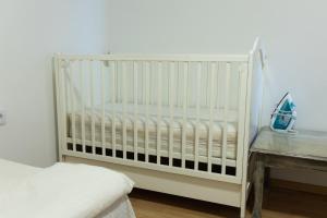 a white crib in a room with a table at Villa Igman in Hrasnica