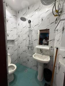 a bathroom with a sink and a toilet and a mirror at Villa soleil du Sénégal in Dakar +82 photos