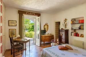 a bedroom with a bed and a desk with a computer at Complesso Villa Le Palme in Forio d'Ischia