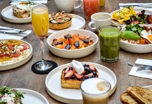 a table with plates of breakfast foods and drinks at Crisol - Frente a la Parroquia de San Miguel Arcángel in San Miguel de Allende