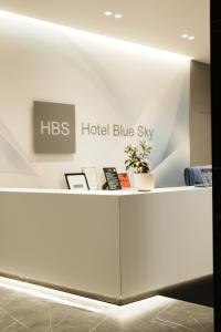 a hotel blue sky sign on a reception desk at Hotel Blue Sky in Sarandë +237 photos