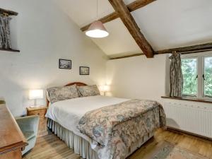 a bedroom with a bed and a window at Allerford- Ukc4920 in Timberscombe